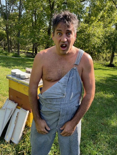 Michael standing by a hive looking startled
